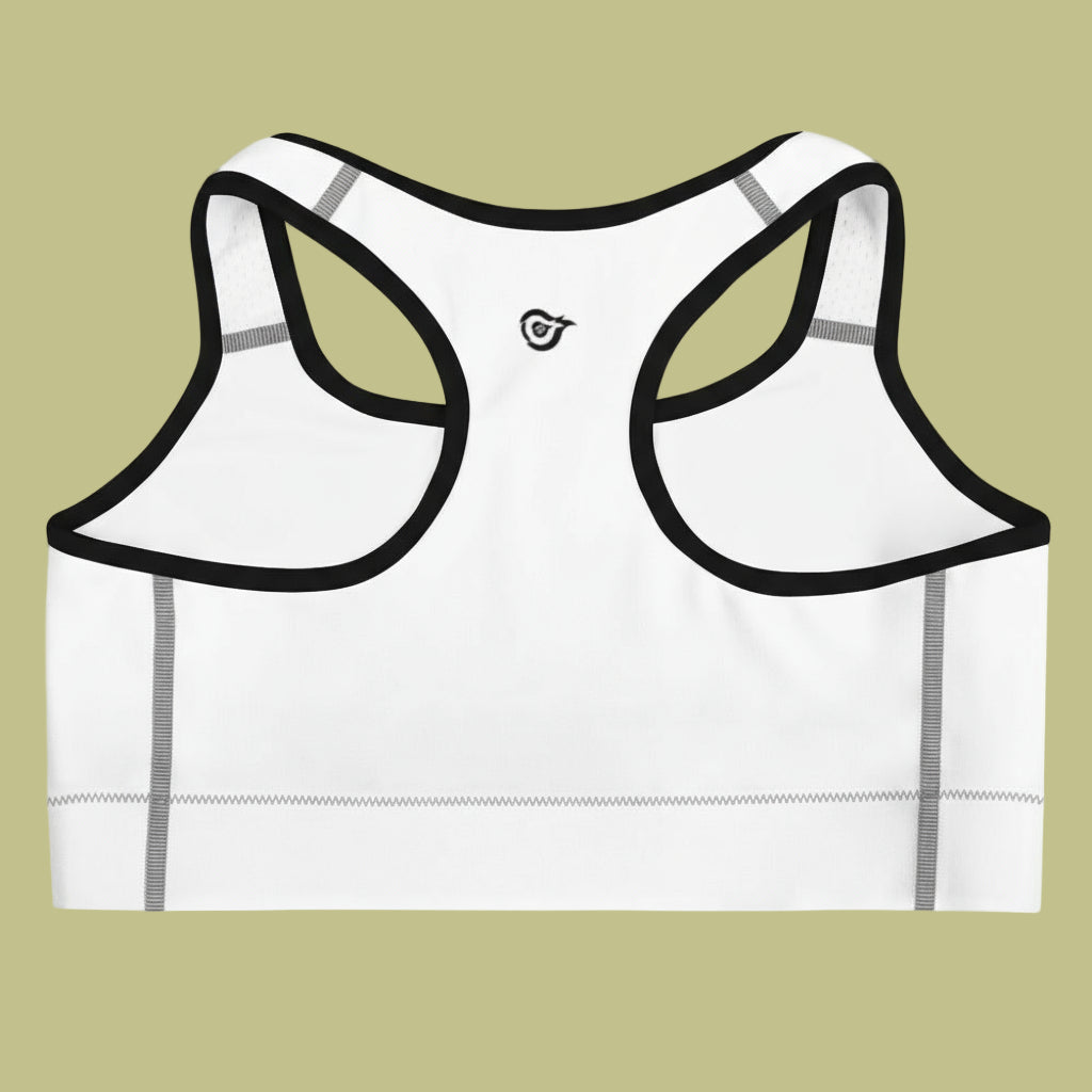 White sports bra with black straps on a beige background