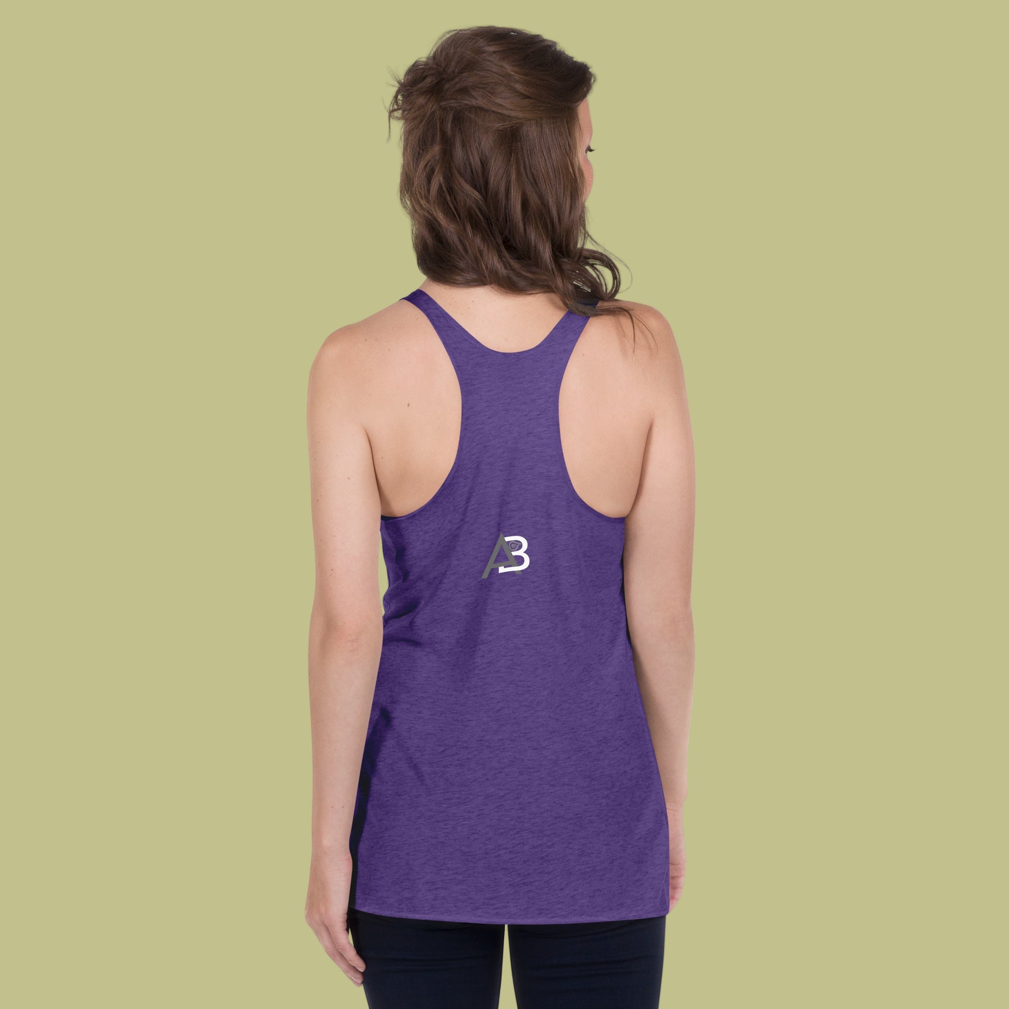 Person wearing a purple tank top with a logo on the back against a green background