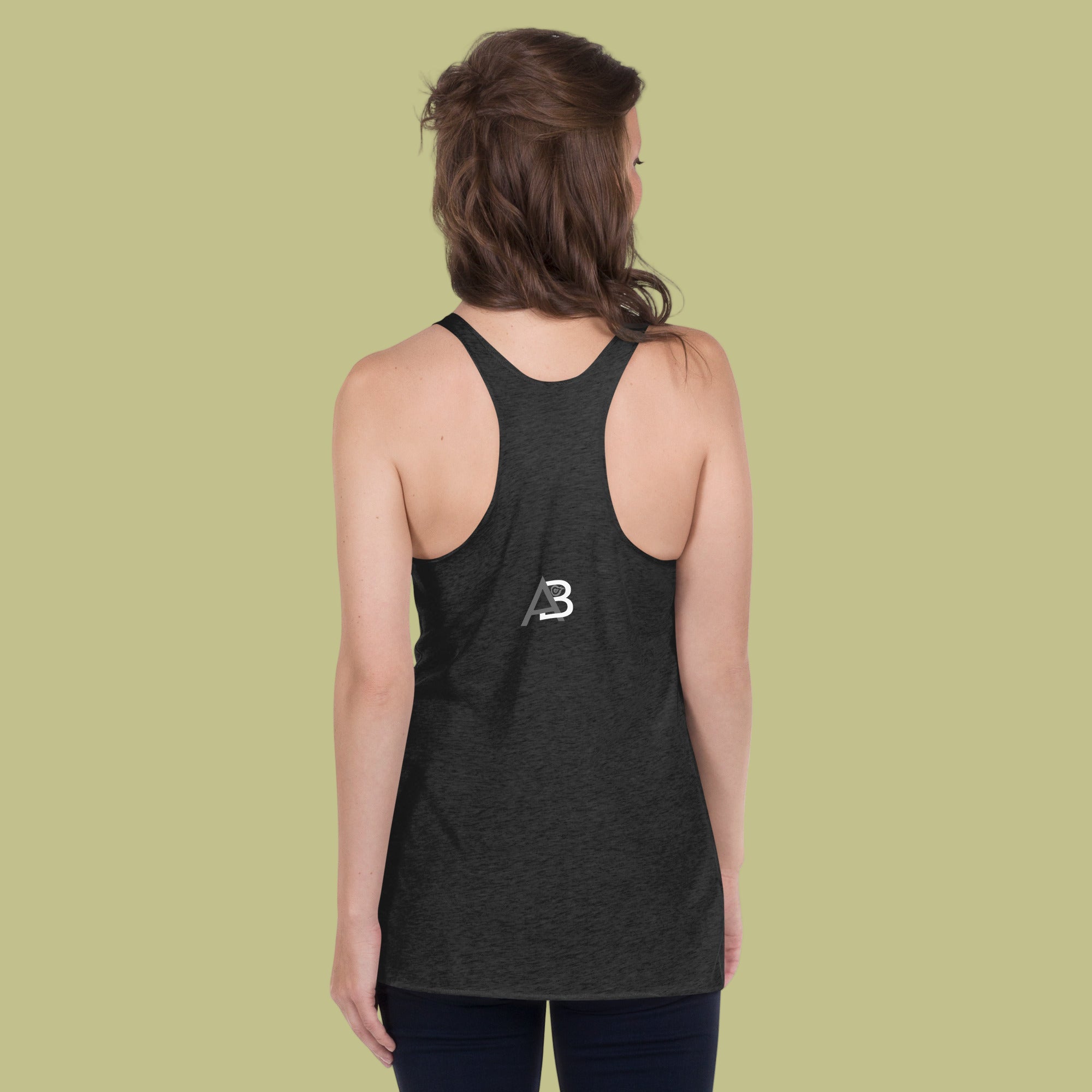Person wearing a black tank top with a logo on the back against a green background