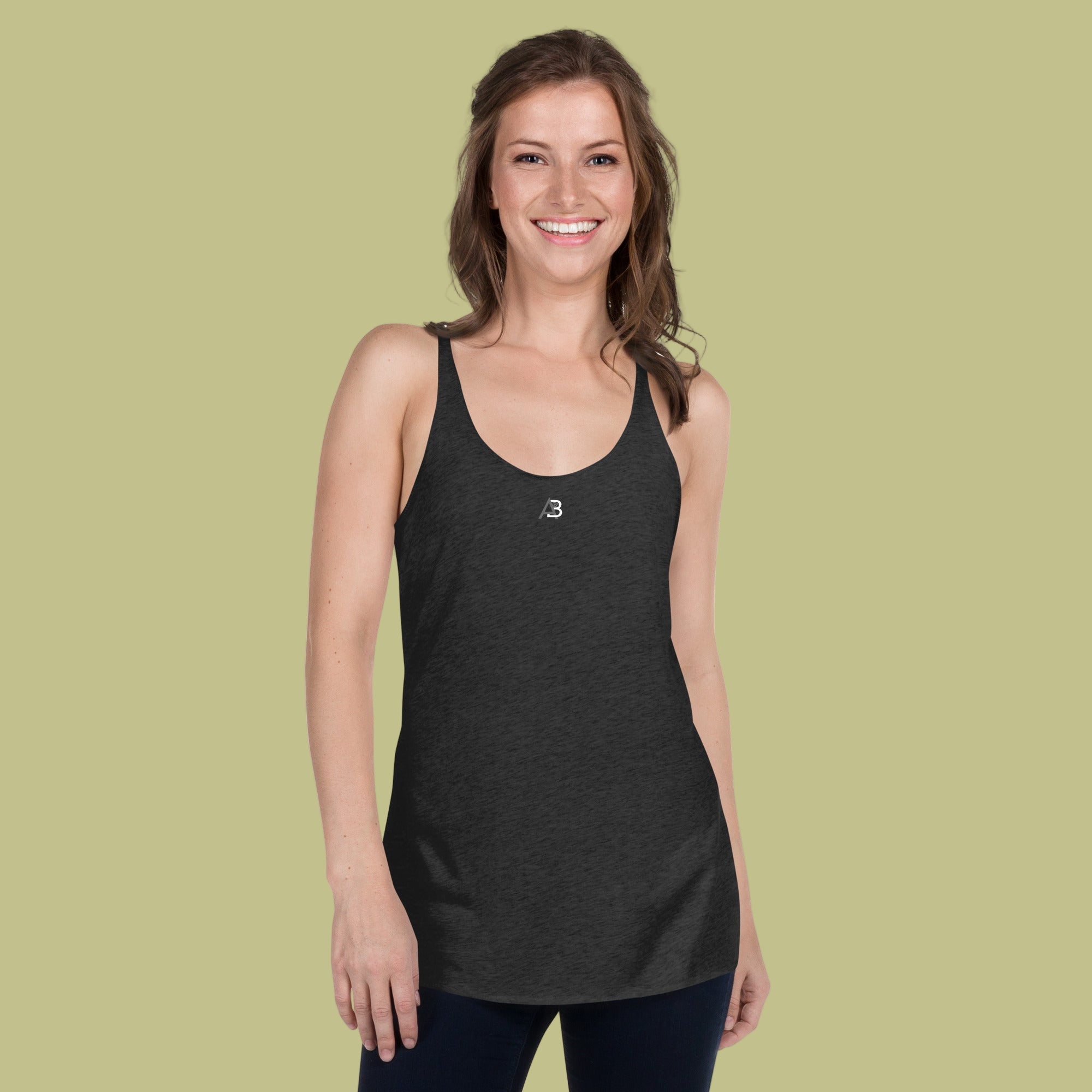Woman wearing a black tank top with a logo on a green background