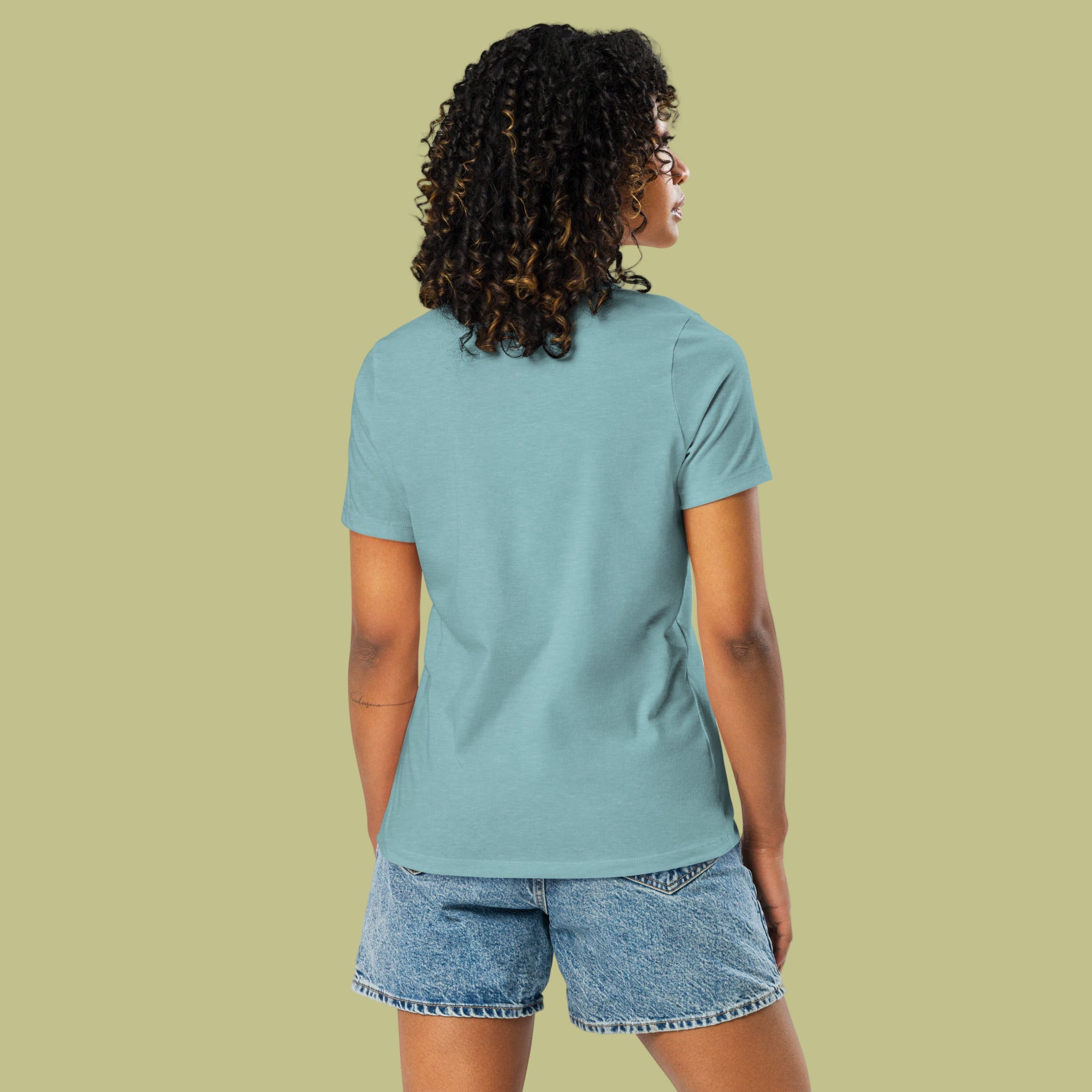 Person wearing a light blue t-shirt and denim shorts on a solid background