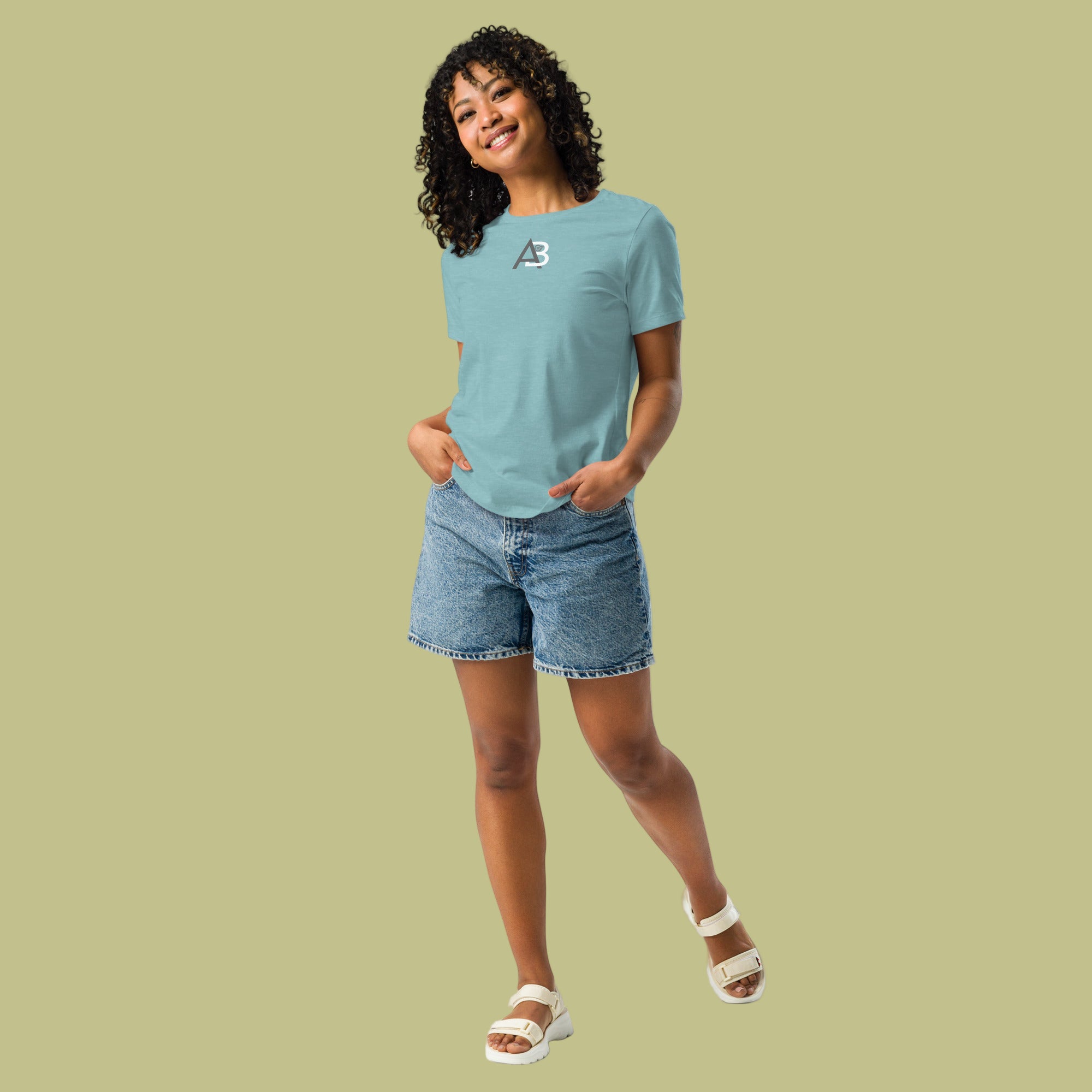 Woman wearing a light blue t-shirt and denim shorts on a white background
