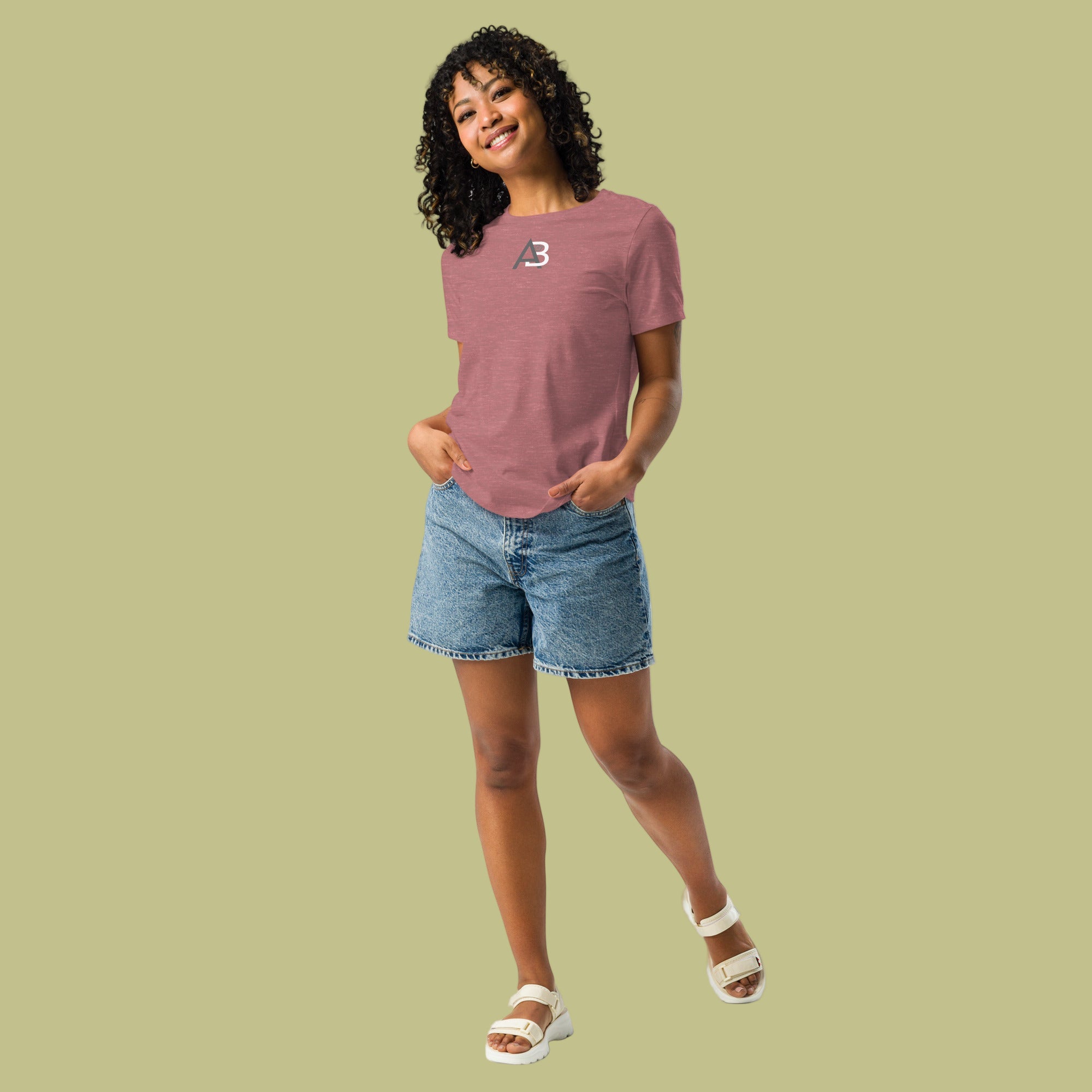 Woman wearing a pink t-shirt and denim shorts on a white background