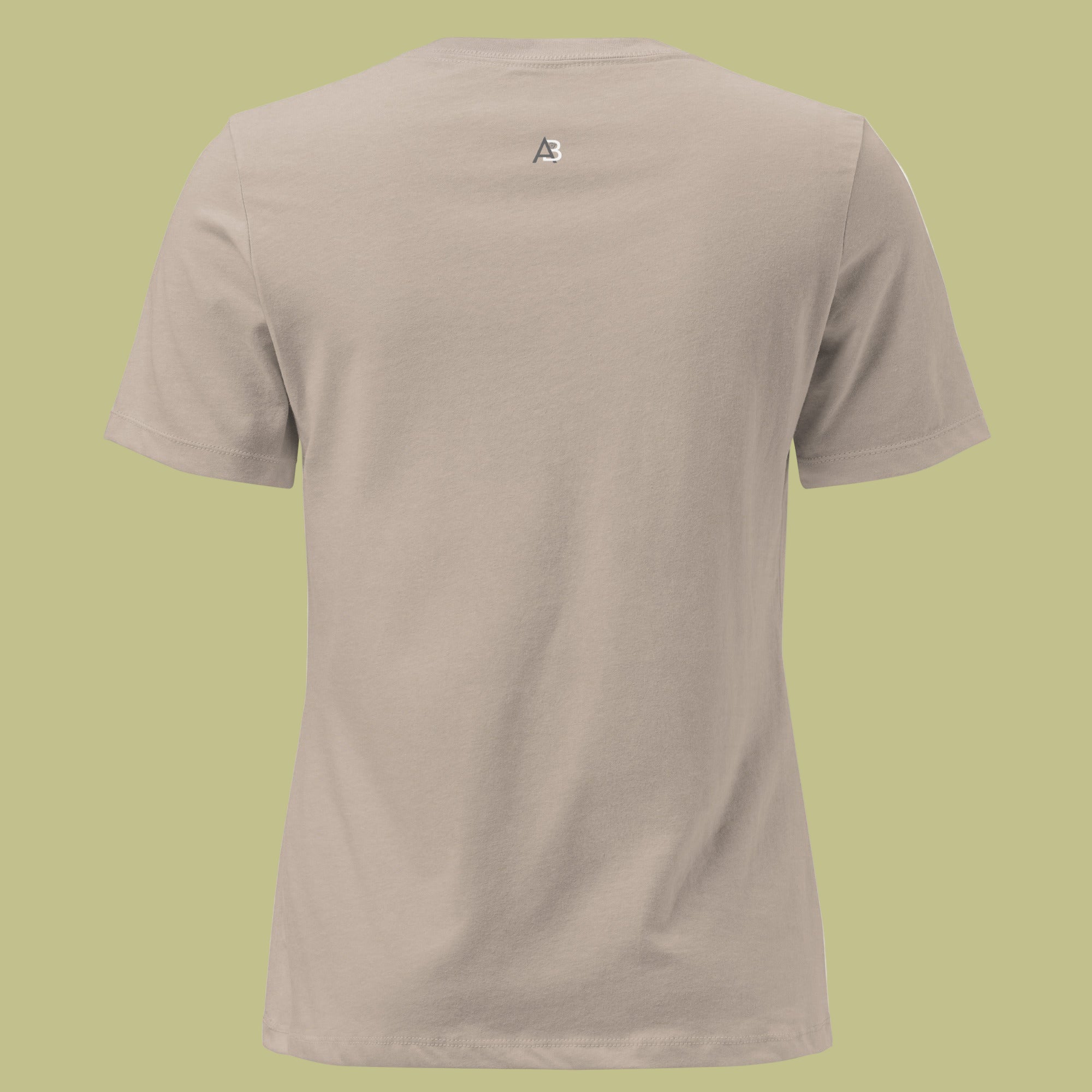 Beige t-shirt with a small logo on the chest against a green background