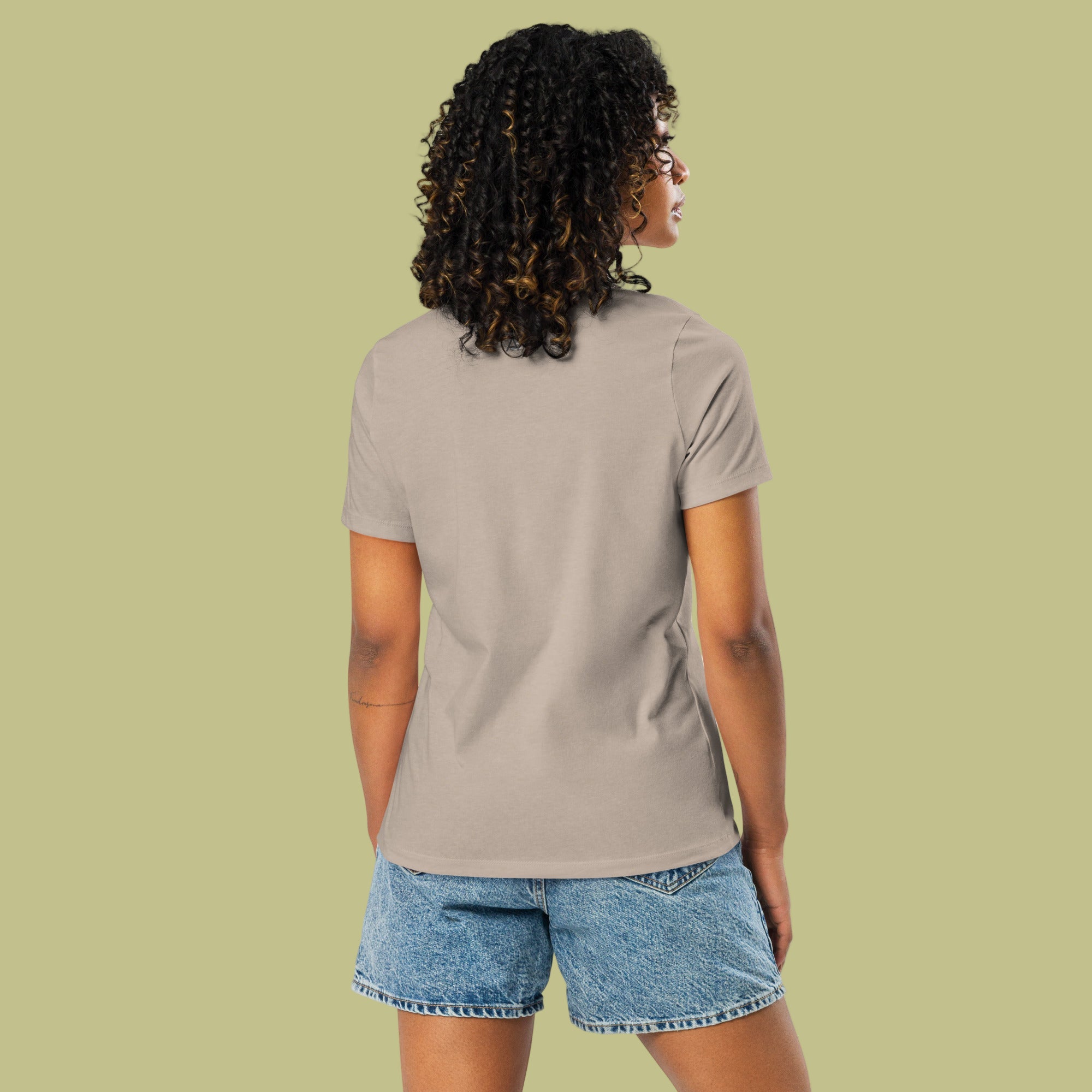 Person wearing a beige t-shirt and denim shorts on a white background