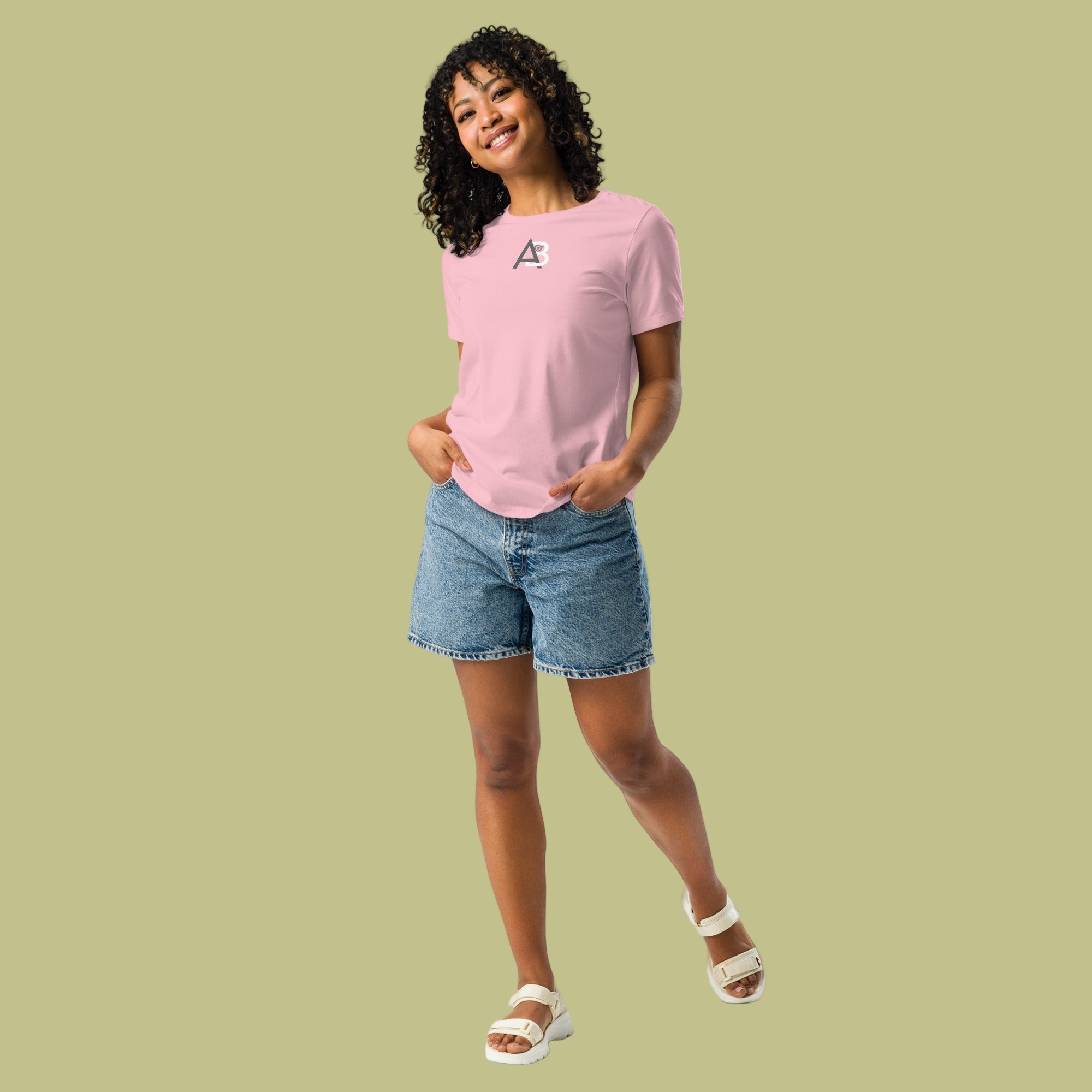 Person wearing a pink t-shirt and denim shorts on a green background